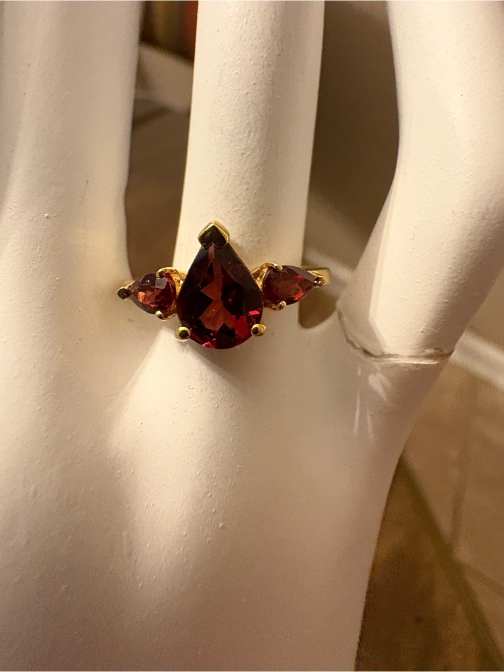 Gold Ring with Deep Red Pear-Cut Gemstone and Side Accents